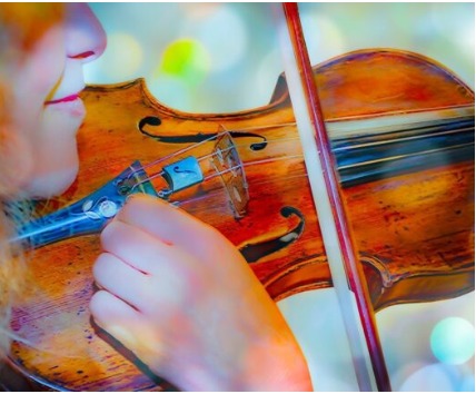 Close-up of a violinist playing, bow drawn across the strings of a warm-toned violin